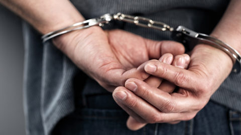 Hands in handcuffs image