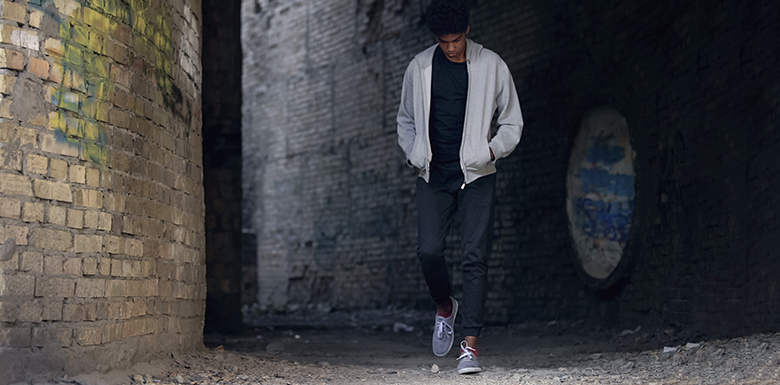 Teenager walking down dark alley