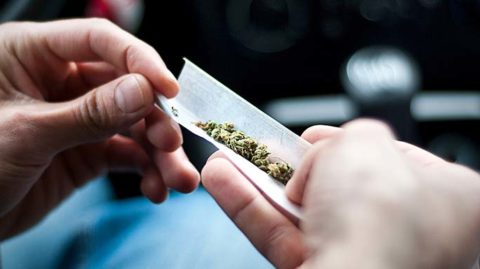 Person using marijuana in car