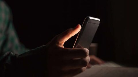 Man using phone in the dark